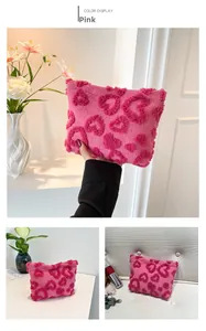 Detail view of the plush pink heart-patterned makeup bag for cosmetics storage