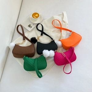 Collection of trendy retro crossbody bags for women with fur pom-poms in vibrant colors