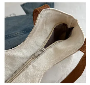 Close-up of the secure zipper closure and durable lining on the canvas tote bag