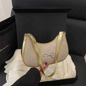 Elegant champagne gold crescent bag with crystal bow and sparkling rhinestones