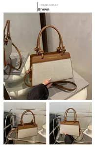 Detail view of brown leather and beige canvas handbag with knotted handle and strap