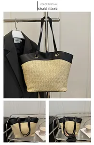Detail of khaki straw tote bag with black leather straps and gold metal ring hardware