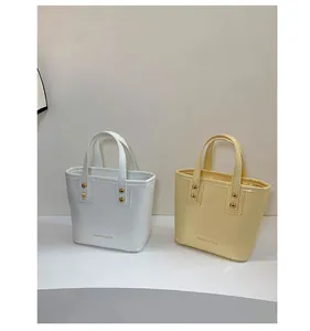 Close-up of mini leather tote bags with gold studs and Fashion & Bags printed text