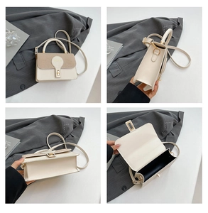 Detail view of cream mini crossbody bag with gold twist lock and woven texture flap