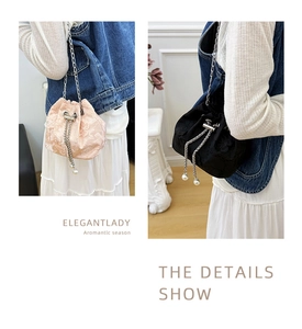 Detail of floral lace embroidery and pearl drawstring on the bucket chain bag