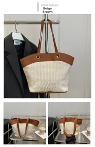 Detail of hand-woven beige straw tote bag with brown leather trim and golden metal rings