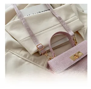 Detailed close-up of adjustable strap buckle and pink tweed texture on a luxury handbag