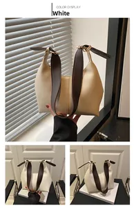 Close-up of beige PU leather shoulder bag with lychee texture and brown strap detail