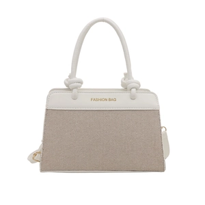Fashionable two-tone tote bag with woven texture and elegant knotted handle details