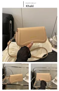Detail view of khaki leather shoulder bag with gold hardware and adjustable strap