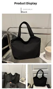 Detailed view of black canvas tote bag showing curved top and folded base texture
