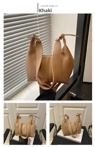 Detailed views of a khaki leather shoulder bag under natural shutter shadow lighting