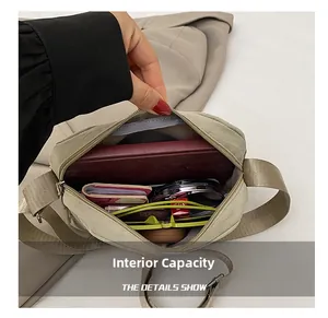Close-up of the khaki nylon crossbody bag interior showing daily items storage capacity