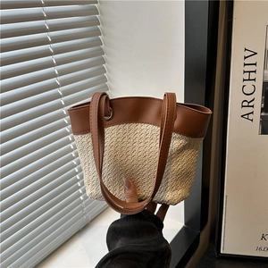 Vintage woven straw tote bag with brown leather handles for summer beach vacations