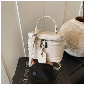 Close-up of cream white leather mini handbag with silver hardware and top handle