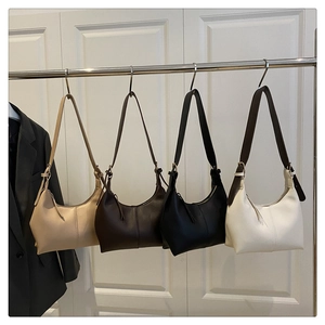 Detailed view of four colorful minimalist crescent bucket bags with adjustable straps