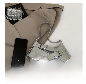 Detail view of silver crescent bag showing capacity with phone and buckle straps