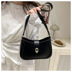 Close-up of black PU leather underarm bag with elegant gold hardware buckle detail