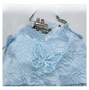 Detail view of the ice blue water bucket bag with mesh butterfly embroidery
