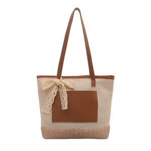 Straw woven bucket bag with brown leather details and lace bow for summer fashion