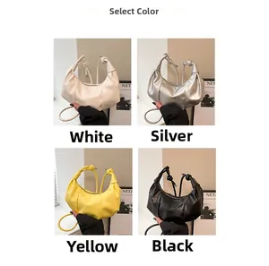 Chic dumpling bag in white, silver, yellow, and black colors with knotted strap detail