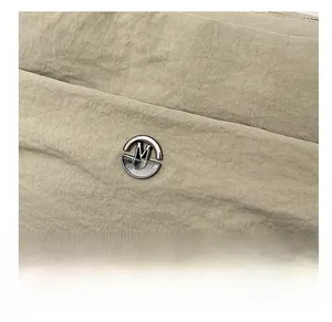 Detailed macro view of khaki fabric texture and silver metal fashion letter buckle