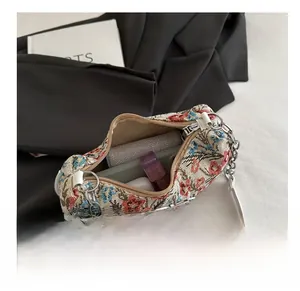 Detailed interior view of floral print chain bag showing capacity for daily essentials