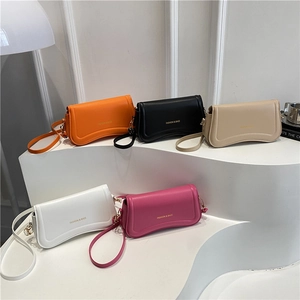 Minimalist square crossbody bags in five colors displayed on a white tiered platform