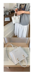 Close-up of white leather bucket bag with gold studs and Fashion & Bags text logo