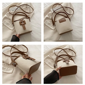 Vue détaillée du sac seau en toile avec garniture en cuir marron et bandoulières réglables