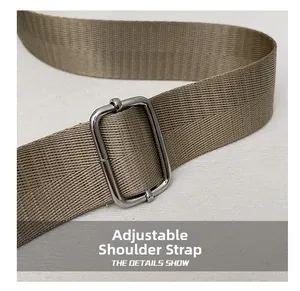 Detail of adjustable shoulder strap with silver buckle on a stylish khaki square bag