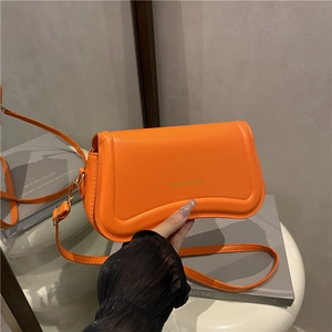 Minimalist orange crossbody shoulder bag with Fashion & Bags text print and gold metal buckle
