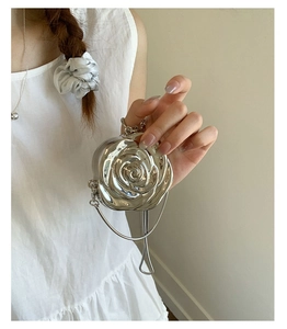 Close-up of silver 3D rose acrylic evening bag with metallic finish and delicate chain strap