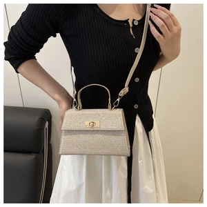 Close-up of sparkling glitter crossbody bag with metallic turn-lock and handle