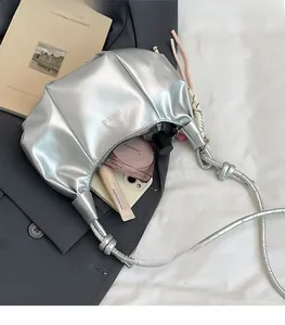 Interior view of silver croissant bag showing spacious capacity for phone and cosmetics