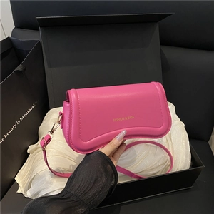 Minimalist rose pink shoulder bag with gold hardware and luxury gift box packaging