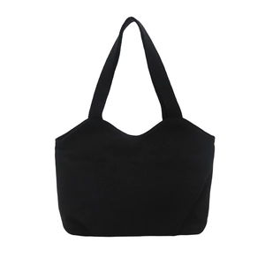 Minimalist black tote bag with unique wavy top edge and canvas shoulder straps