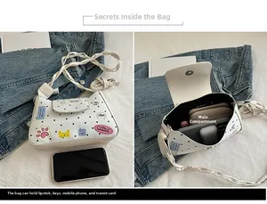 Polka dot shoulder bag showing internal capacity for phone and makeup accessories
