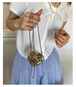 Detailed close-up of a mini gold 3D rose flower chain bag with mirror finish luster