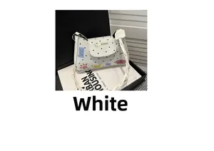 Detailed close-up of white tote bag with black polka dots and colorful graffiti patches