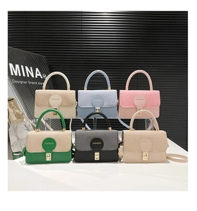 Detailed view of fashionable patchwork handbags in six colors with gold clasp and top handle
