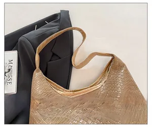 Detail showing woven texture and precise stitching on the khaki hobo bag shoulder strap