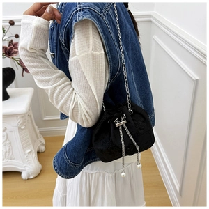 Détail du sac seau noir brodé avec chaîne argentée et ornements en perles