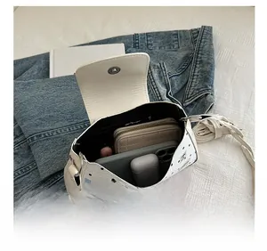Detailed internal view showing large capacity for phone and wallet in white polka dot bag