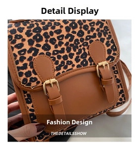 Macro shot of vintage leopard print crossbody bag with gold hardware and leather trim