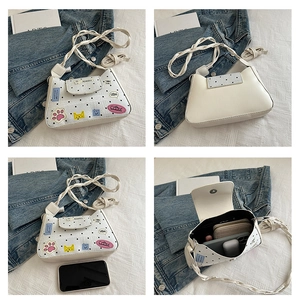 Internal view showing large capacity for phone and wallet in white polka dot bag