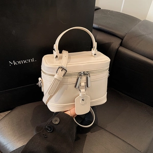Cream white synthetic leather box crossbody bag with silver hardware and adjustable strap