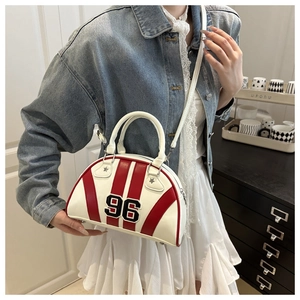 Détail du sac bowling rayé rouge et blanc avec écusson numéro 96 et rivets étoiles