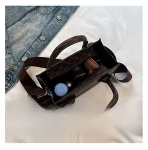 Top view of mini tote bag interior capacity showing cosmetics and patterned leather