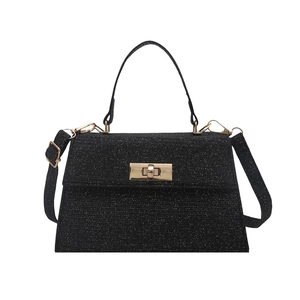 Sparkly black Kelly handbag with golden twist lock and detachable crossbody strap